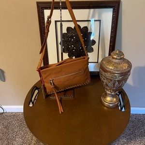 Jennifer Lopez Contemporary crossbody w/side zipper and adjustable strap.NWT